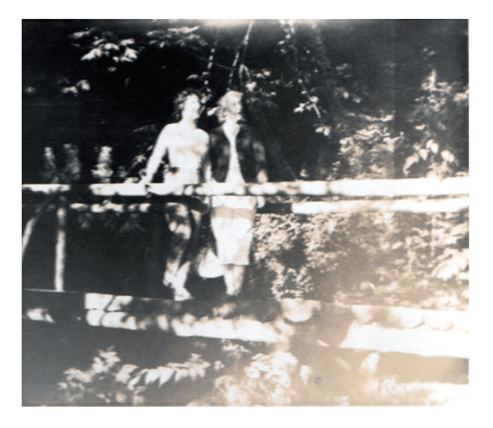 Two women posting on a wooden bridge